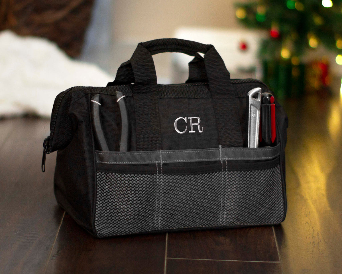 Close view of the embroidered CR monogram on the front panel of the tool bag