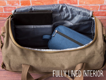 Interior of the washed canvas weekender showing the two zip pockets and polyester lining