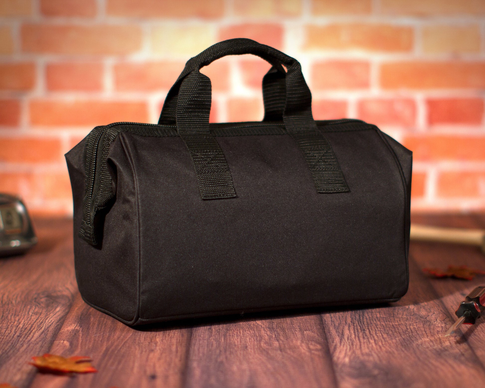 Plain black soft-sided tool bag with reinforced carry handles and wide-mouth opening