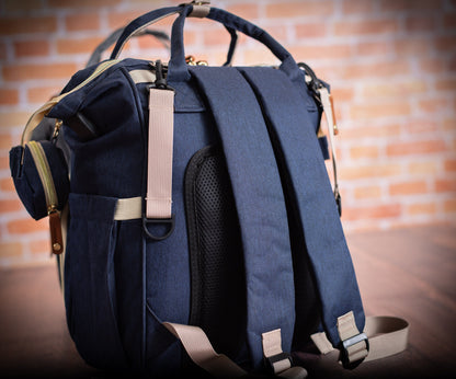 The Nursery Run Diaper Backpack — back view showing padded backpack straps, mesh panel and stroller clips