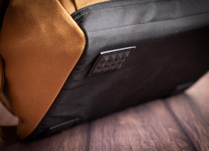 Underside of the canvas tool bag showing the dark base and protective pads.